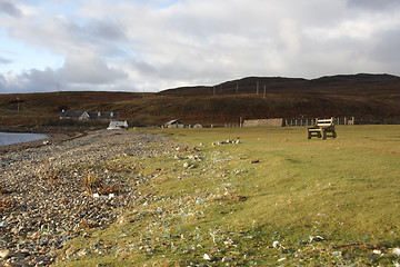 Image showing peaceful coastal scenery with bench