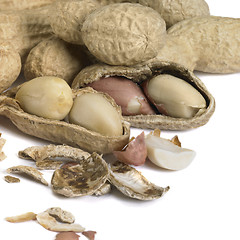 Image showing half peeled peanut