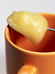 Image showing cup and honey spoon