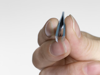 Image showing hand and tweezers