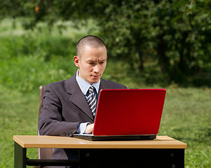 Image showing man with laptop working outdoors