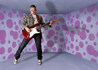 Image showing punk man in cardboard room with the guitar