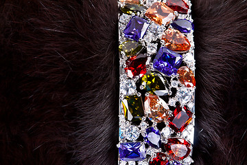 Image showing bracelet with precious stones in a dark fur