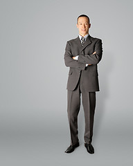 Image showing smiling standing businessman in suit 