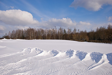 Image showing Snow pushed into piles in the park winter backdrop 