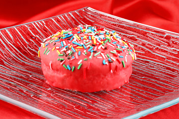 Image showing Pink glazed muffin with sprinkles