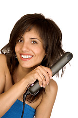 Image showing woman using hair straighteners