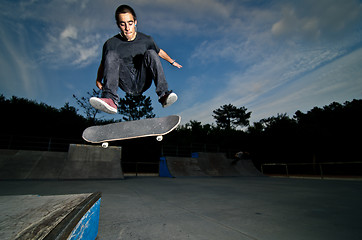 Image showing Skateboarder on a flip trick