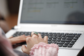 Image showing Young woman working on laptop