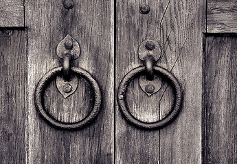 Image showing ancient wooden gate with door knocker rings