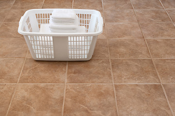 Image showing White towels stacked in a laundry basket