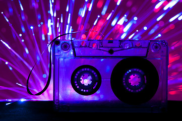 Image showing Transparent Cassette tape and disco light background