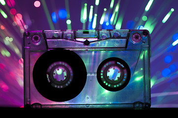 Image showing Transparent Cassette tape and disco light background