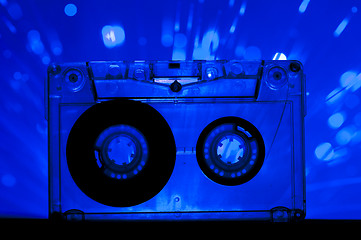 Image showing Transparent Cassette tape and disco light background