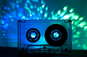 Image showing Transparent Cassette tape and disco light background