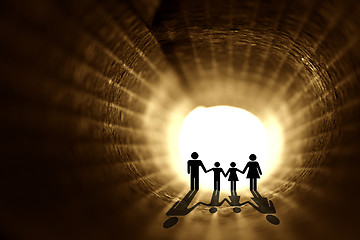 Image showing In to the light. Family silhouette inside the rolled paper