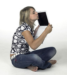 Image showing cute blonde girl kissing her laptop