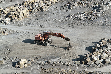 Image showing resting quarry digger and stones