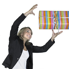 Image showing smiling girl is catching a present