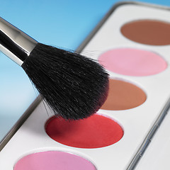 Image showing make-up colors and brush