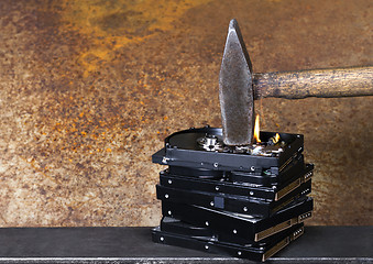 Image showing hammer and burning hard disks