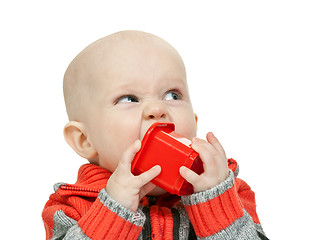 Image showing little boy chewing on a plastic pyramid in the studio