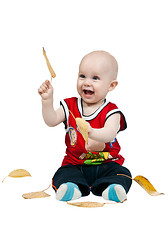 Image showing little boy with autumn leaves in the studio