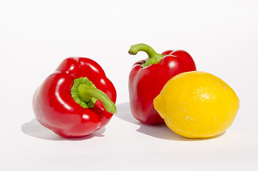 Image showing Red paprikas and yellow lemon.