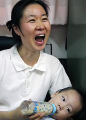 Image showing Mother feeding her baby - surprised expression