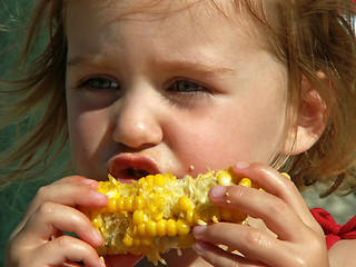 Image showing girl eating corn on the cob