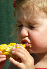 Image showing litle girl eating corn on the cob