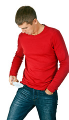 Image showing man looks with interest at his empty pocket