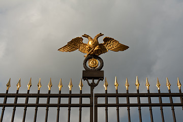 Image showing gold double eagle on a steel fence