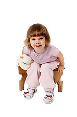 Image showing little girl sitting on a wooden stool