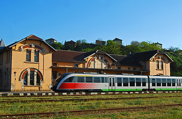 Image showing Old railway station, modern train