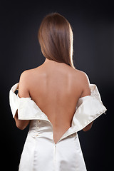 Image showing pretty girl with bare back in the studio