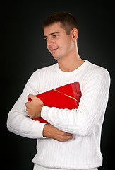 Image showing sad man with a red gift box in a studio