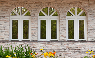Image showing Three windows in the stone wall