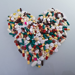 Image showing various pills in a shape of heart