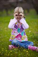 Image showing Little girl outdoors with imaginary binoculars