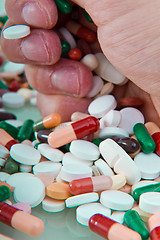 Image showing hand grabbing pills