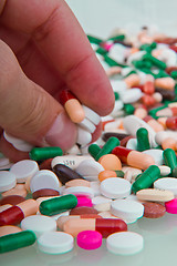 Image showing hand grabbing pills