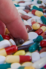 Image showing hand grabbing pills