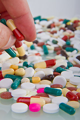 Image showing hand grabbing pills