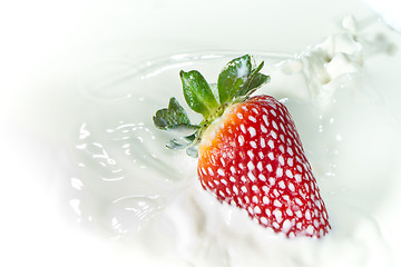 Image showing strawberry splashing into milk