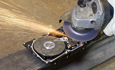 Image showing angular grinder cleaning data from hard drive