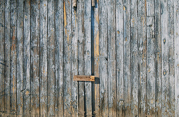 Image showing Old faded blue wooden fence door