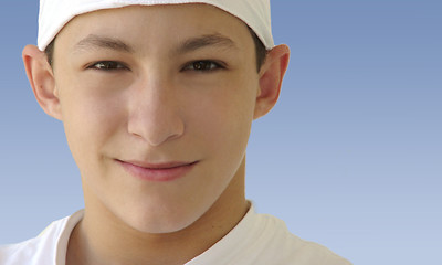 Image showing Boy in a white hat isolated on blue