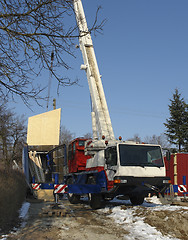 Image showing wooden house construction at winter time