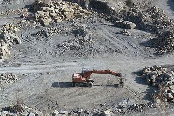 Image showing resting quarry digger and stones